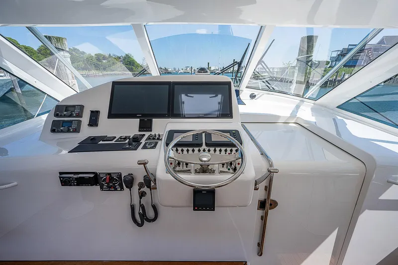 Slide: The Image of Helm of 2012 Cabo 44 HTX yacht with modern navigation equipment. - 19