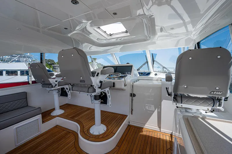 Slide: The Image of Interior of 2012 Cabo 44 HTX yacht with helm chairs and wooden flooring. - 23