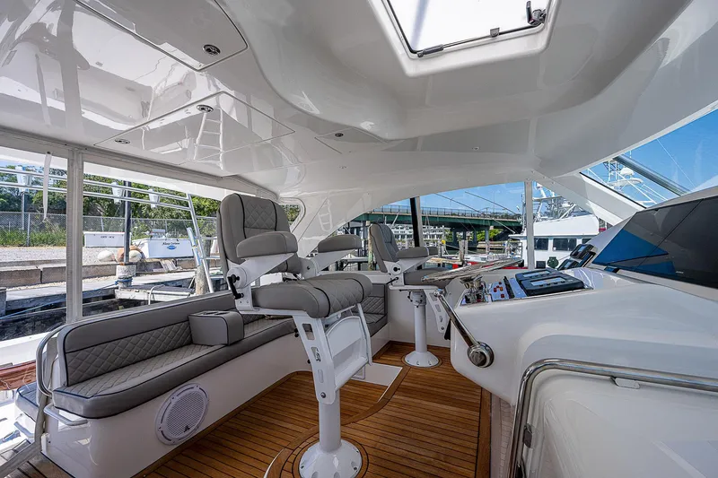 Slide: The Image of Luxurious 2012 Cabo 44 HTX yacht interior with plush seating and modern controls. - 28
