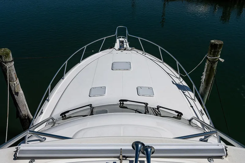 Slide: The Image of Bow view of 2012 Cabo 44 HTX yacht docked at marina. - 29