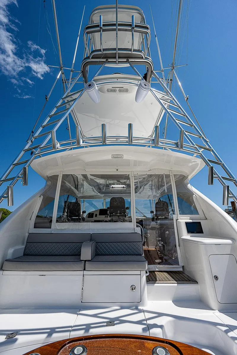 Slide: The Image of 2012 Cabo 44 HTX yacht with tower, sleek design, and spacious deck under clear blue sky. - 36