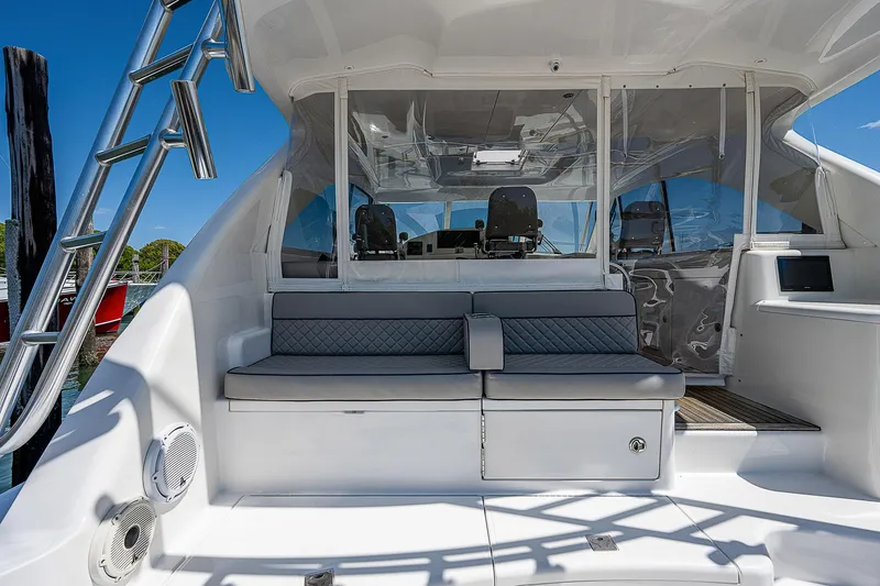 Slide: The Image of Cabo 44 HTX 2012 yacht cockpit with seating and ladder, showcasing luxury design. - 38