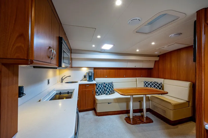 Slide: The Image of Luxurious interior of 2012 Cabo 44 HTX yacht with modern kitchen and cozy dining area. - 7