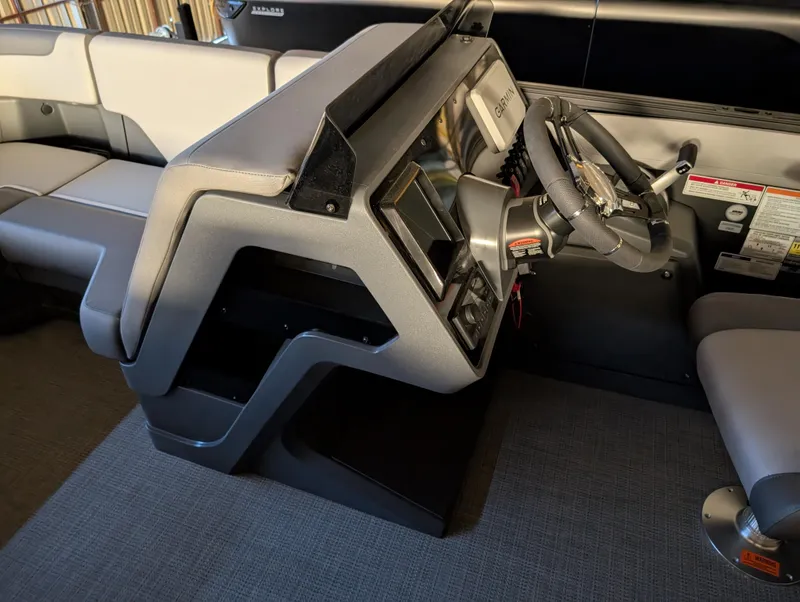 Slide: The Image of 2025 Manitou Cruise boat interior with modern steering console and seating. - 13