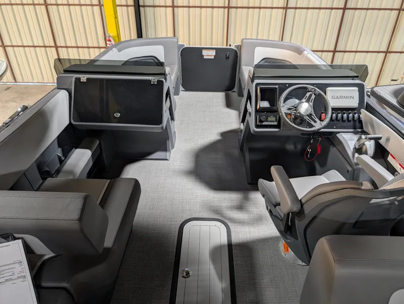 Slide: The Image of Interior of a 2025 Manitou Cruise boat, featuring modern seating and a Garmin-equipped dashboard. - 3