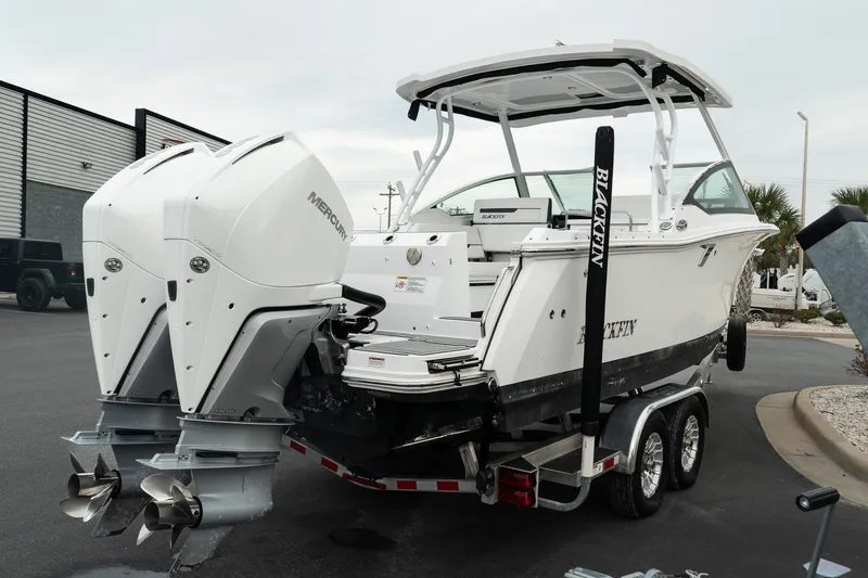 Slide: The Image of 2023 Blackfin 272 DC boat with dual Mercury outboard engines on a trailer. - 11