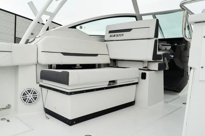 Slide: The Image of 2023 Blackfin 272 DC boat interior with white seating and modern design. - 14