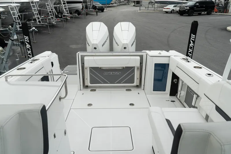Slide: The Image of 2023 Blackfin 272 DC boat interior with dual engines and spacious deck layout. - 15