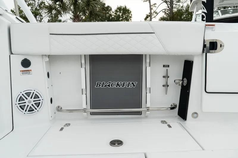 Slide: The Image of 2023 Blackfin 272 DC boat interior with sleek white design and branded panel. - 17