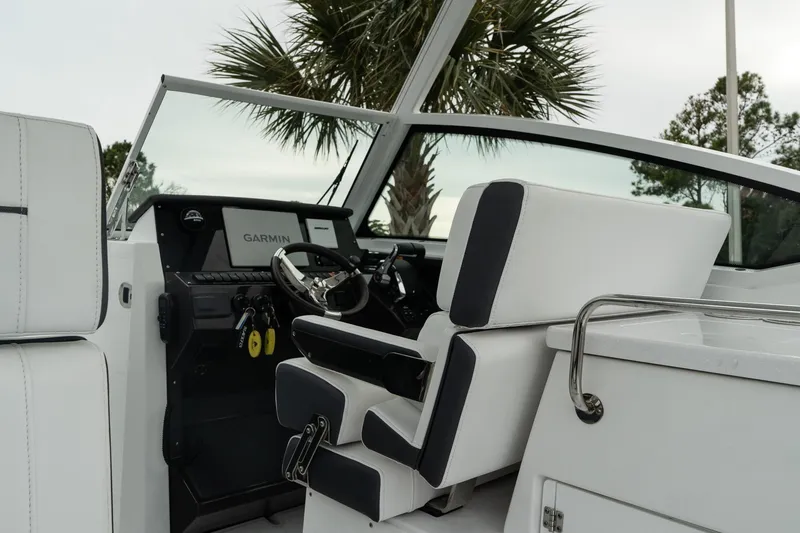 Slide: The Image of 2023 Blackfin 272 DC boat interior with modern steering and Garmin navigation system. - 18