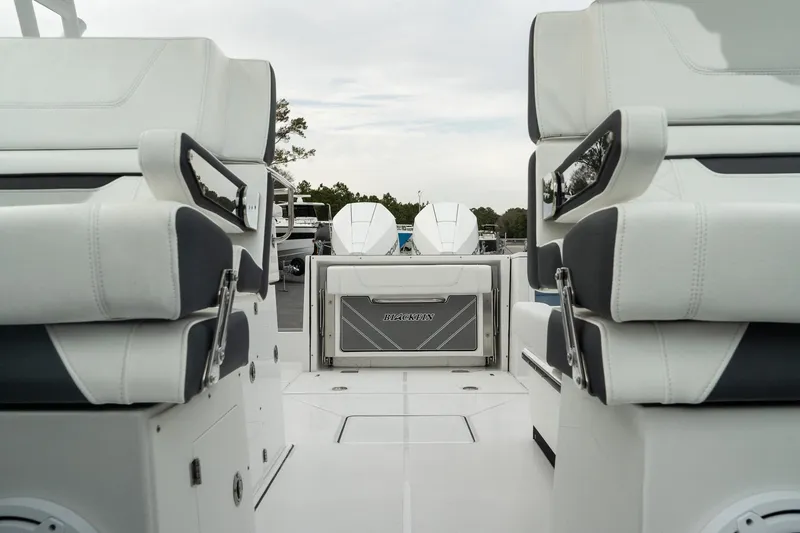 Slide: The Image of 2023 Blackfin 272 DC boat interior with dual seating and twin engines. - 20