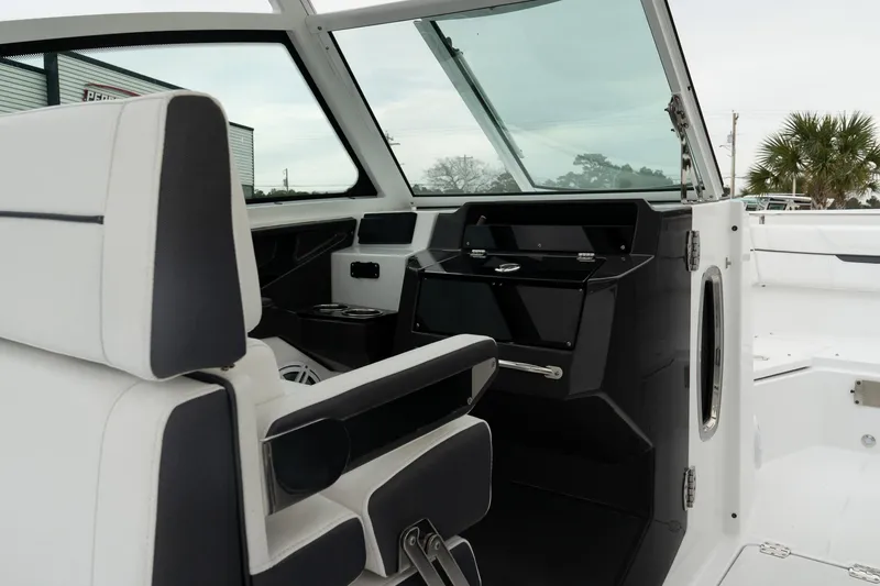 Slide: The Image of 2023 Blackfin 272 DC boat interior with modern helm and seating. - 23
