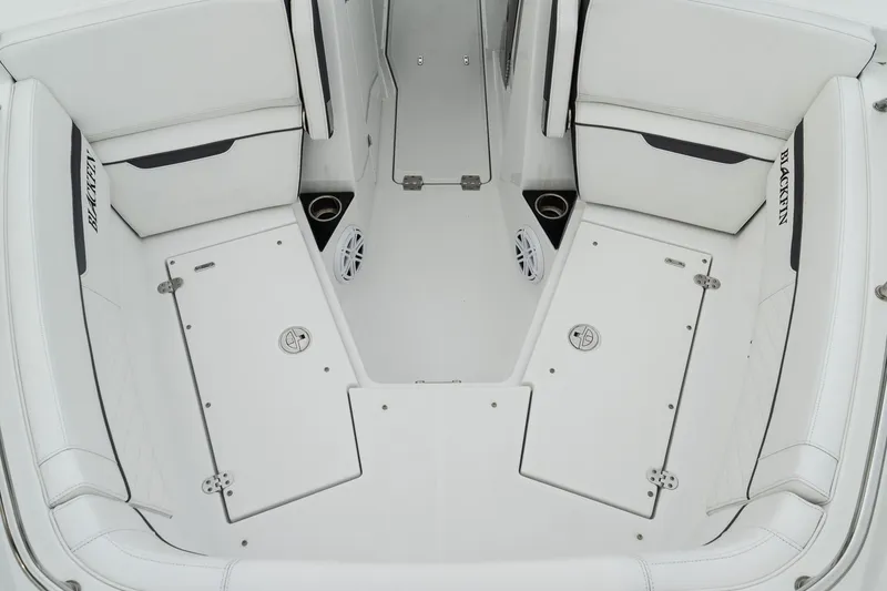 Slide: The Image of 2023 Blackfin 272 DC boat interior with white seating and storage compartments. - 27