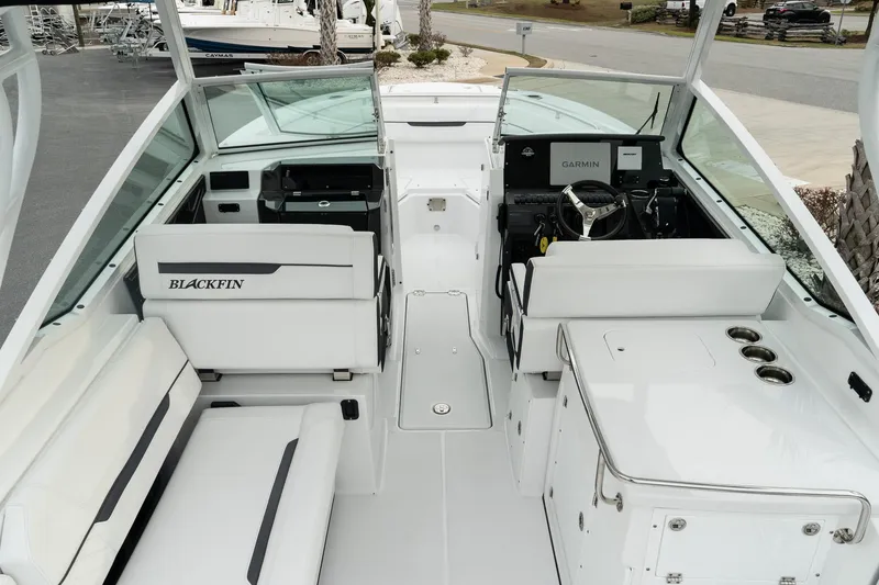 Slide: The Image of 2023 Blackfin 272 DC boat interior with seating and helm, showcasing modern design. - 29
