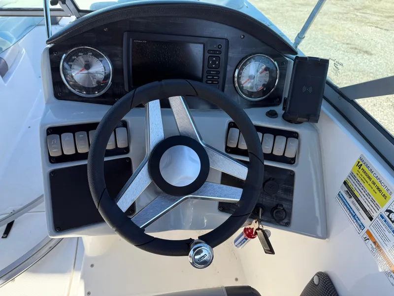 Slide: The Image of Steering console of 2018 Hurricane SunDeck 2486 OB boat with gauges and controls. - 17