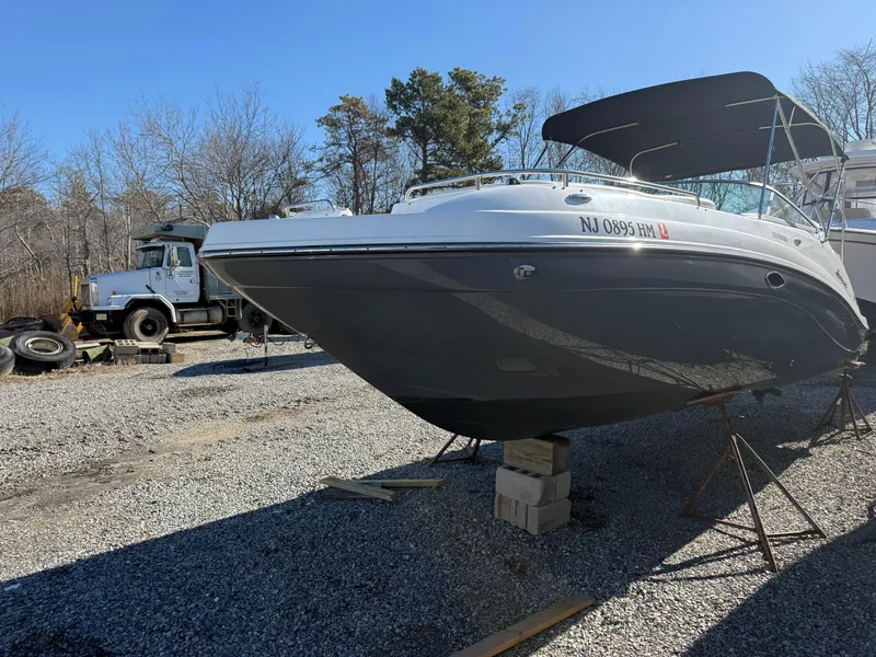 Slide: The Image of 2018 Hurricane SunDeck 2486 OB boat on blocks in a gravel lot. - 19