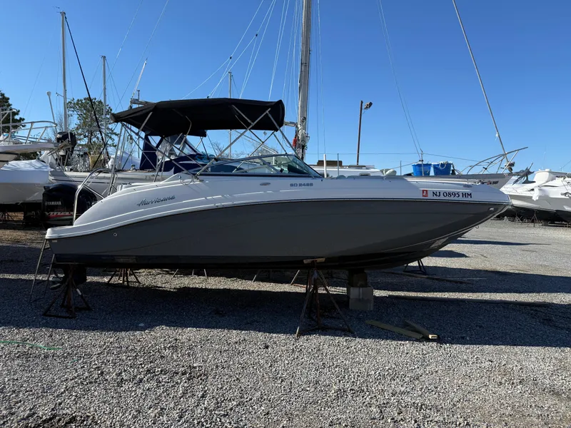 Slide: The Image of 2018 Hurricane SunDeck 2486 OB boat on gravel lot, side view. - 22
