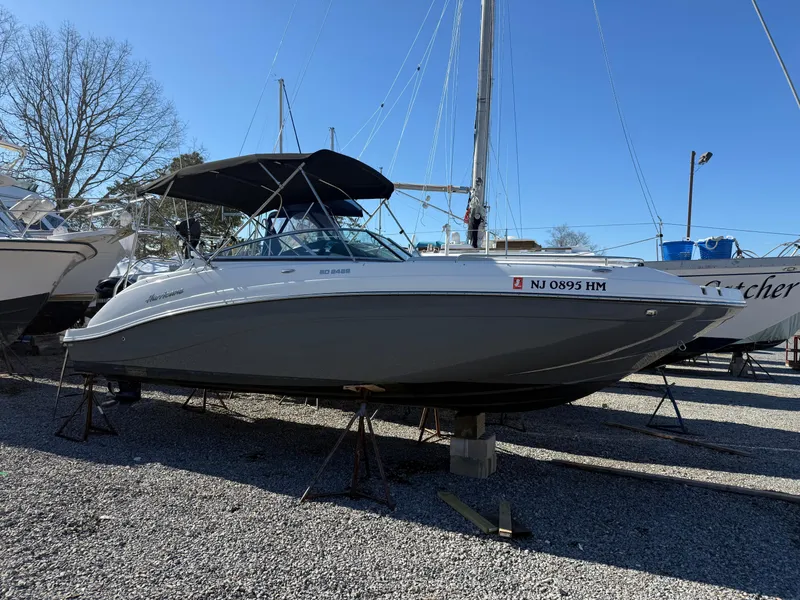 Slide: The Image of 2018 Hurricane SunDeck 2486 OB boat on stands in a marina. - 23