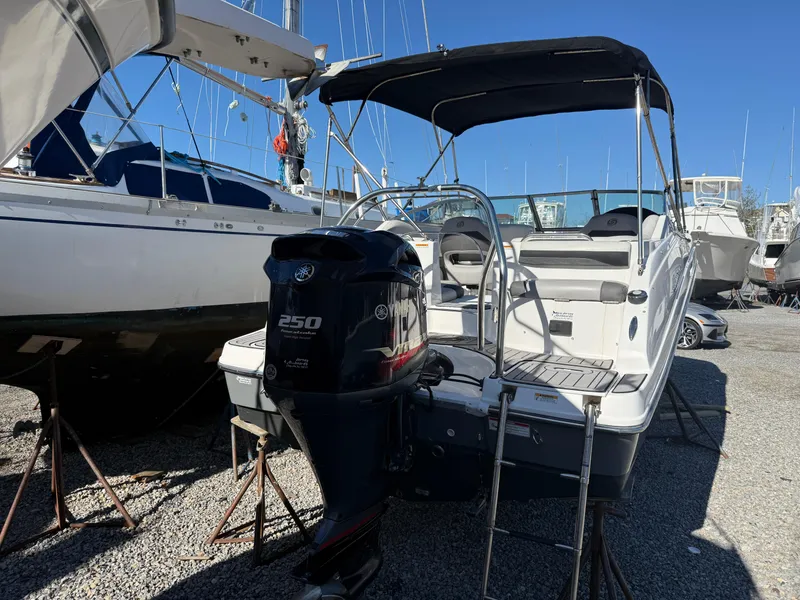 Slide: The Image of 2018 Hurricane SunDeck 2486 OB boat with Yamaha 250 engine, docked in a marina. - 24