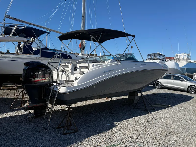 Slide: The Image of 2018 Hurricane SunDeck 2486 OB boat on display in a marina, featuring a Yamaha outboard motor. - 25