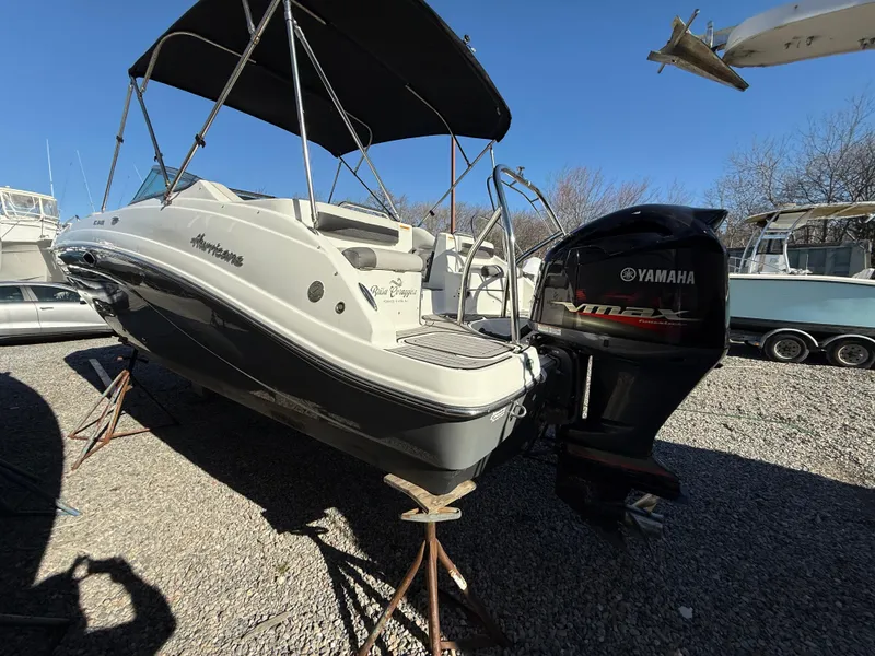 Slide: The Image of 2018 Hurricane SunDeck 2486 OB boat with Yamaha outboard motor, parked on gravel. - 26