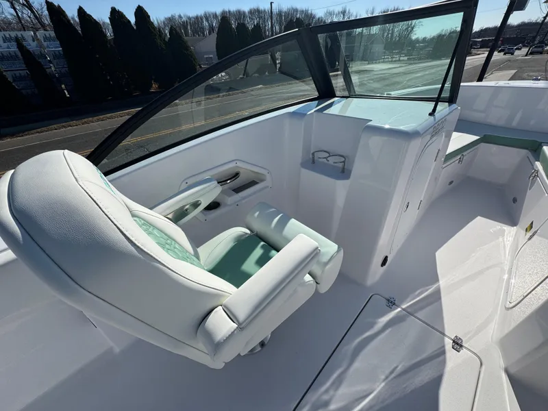 Slide: The Image of 2025 Aquasport 22AS Dual Console boat interior with white seating and windshield. - 10