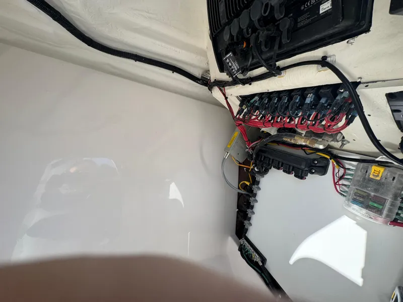 Slide: The Image of Electrical panel of 2025 Aquasport 22AS Dual Console boat, showcasing wiring and components. - 11
