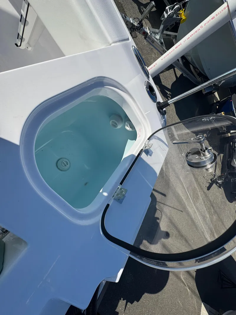 Slide: The Image of 2025 Aquasport 22AS Dual Console boat interior with livewell and windshield. - 16