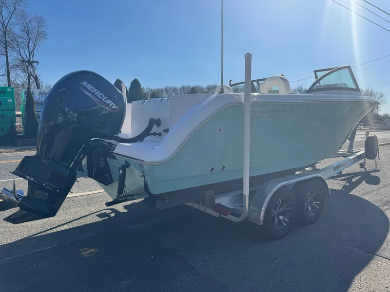 Slide: The Image of 2025 Aquasport 22AS Dual Console boat on trailer with Mercury outboard motor. - 2