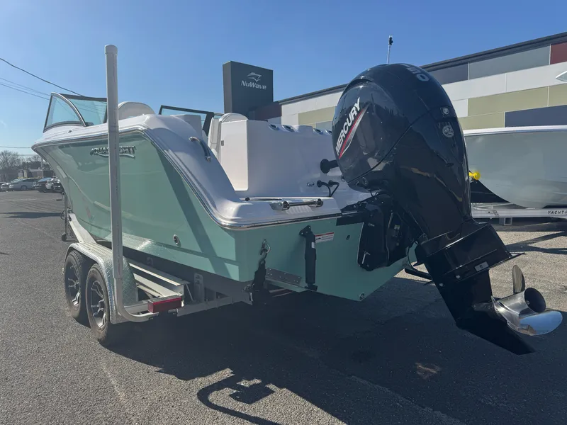 Slide: The Image of 2025 Aquasport 22AS Dual Console boat on trailer with outboard motor, parked outdoors. - 3