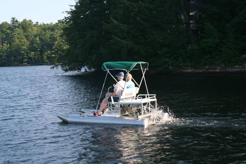 Slide: The Image of 2024 Aqua Cycle AC15W pedal boat on a serene lake with lush forest backdrop. - 3