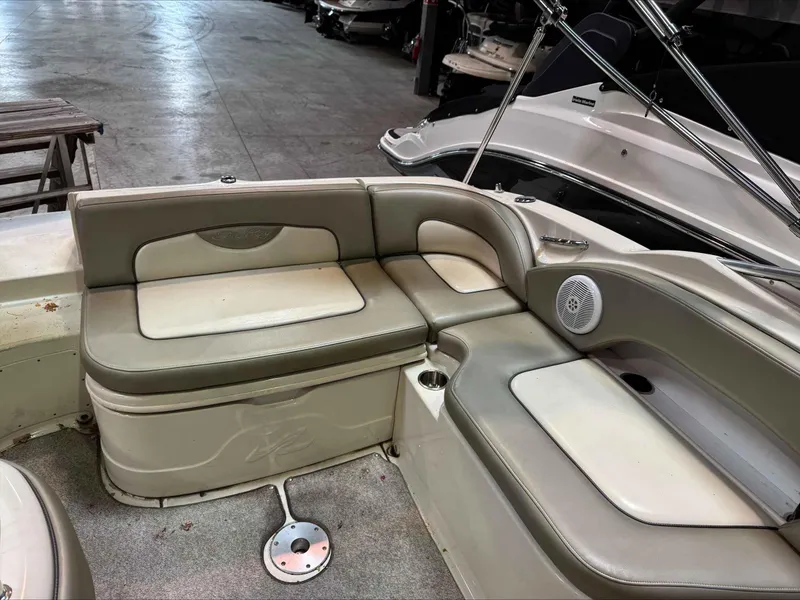 Slide: The Image of 2005 Sea Ray 270 Sundeck interior seating with beige upholstery and speaker. - 10
