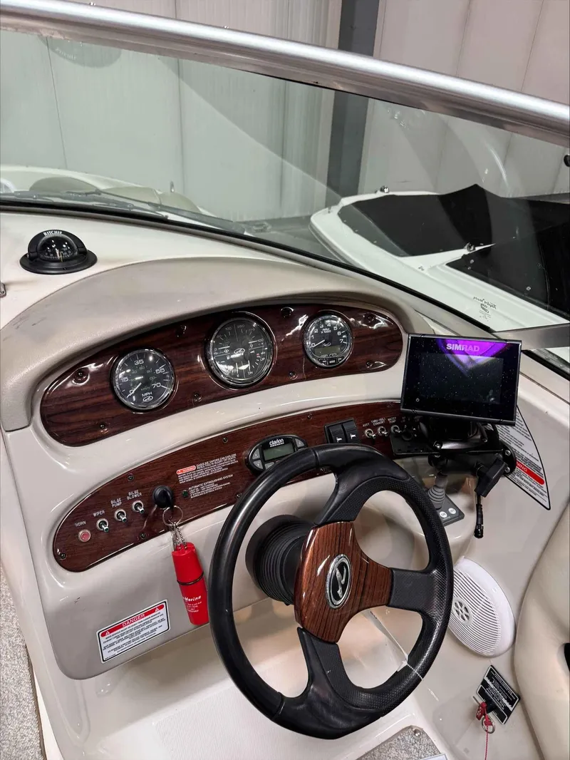 Slide: The Image of 2005 Sea Ray 270 Sundeck dashboard with steering wheel and navigation system. - 11
