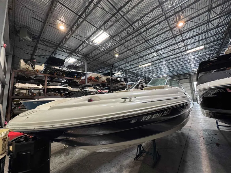 Slide: The Image of 2005 Sea Ray 270 Sundeck boat stored in a spacious indoor facility. - 3
