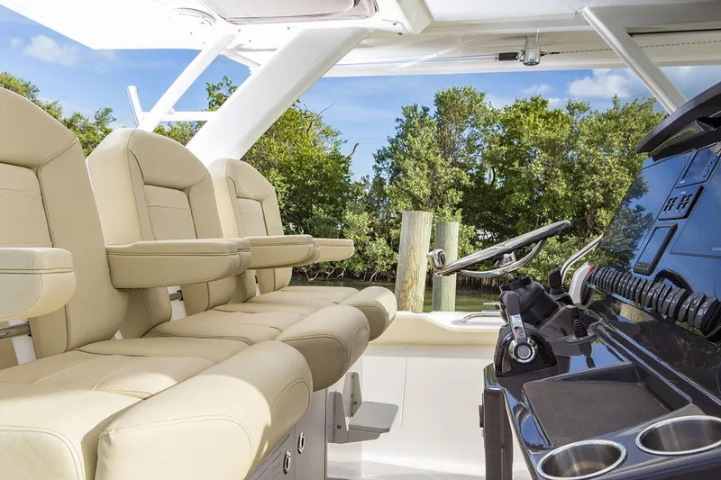 Slide: The Image of 2019 Pursuit S 408 Sport boat with enclosed seating area and American flag. - 15