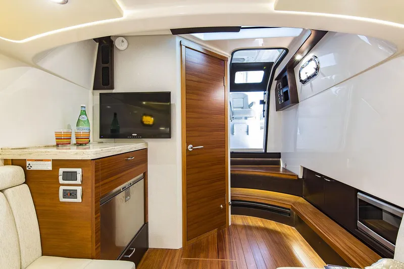 Slide: The Image of 2019 Pursuit S 408 Sport boat docked at marina with triple outboard engines. - 20