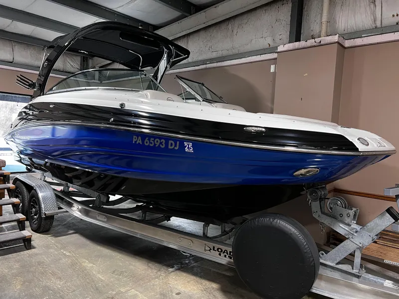 Slide: The Image of 2013 Crownline Eclipse E4 boat on trailer in indoor storage. - 0