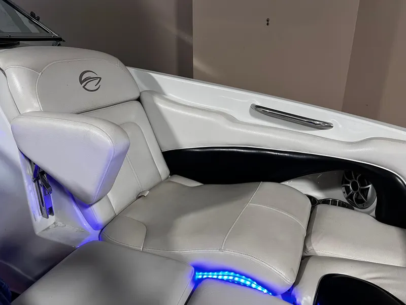 Slide: The Image of 2013 Crownline Eclipse E4 boat interior with white seating and blue LED lighting. - 12