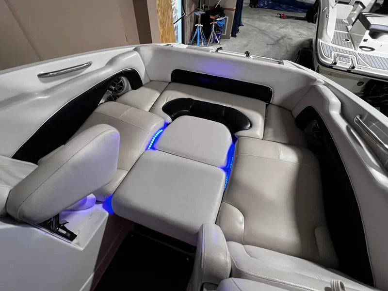 Slide: The Image of 2013 Crownline Eclipse E4 boat interior with white seating and blue LED lighting. - 14