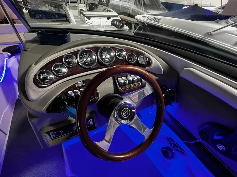 Slide: The Image of 2013 Crownline Eclipse E4 dashboard with illuminated gauges and wood-accented steering wheel. - 17