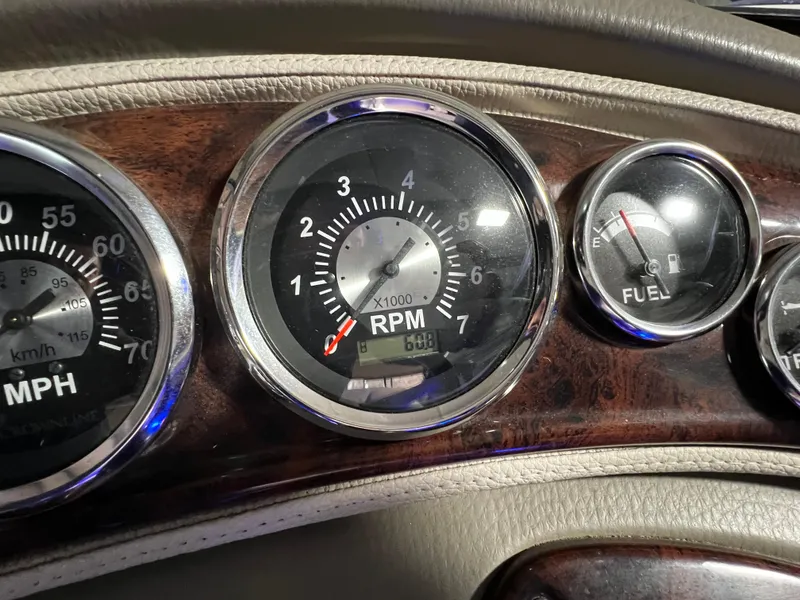 Slide: The Image of Dashboard gauges of a 2013 Crownline Eclipse E4 boat, showing RPM and fuel levels. - 18