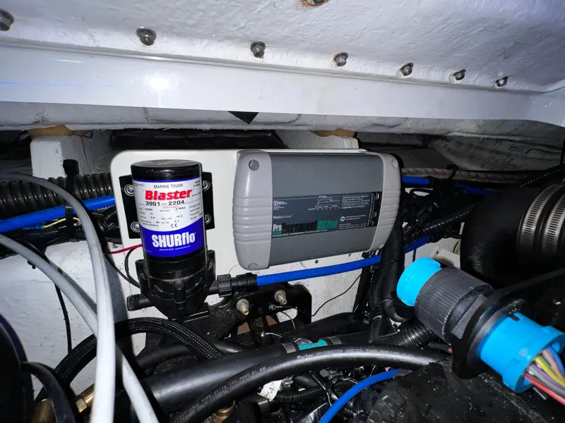 Slide: The Image of Engine compartment of 2013 Crownline Eclipse E4 with Shurflo Blaster pump and wiring. - 23