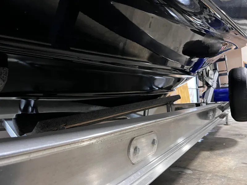 Slide: The Image of 2013 Crownline Eclipse E4 boat on trailer, close-up view of hull and support. - 29