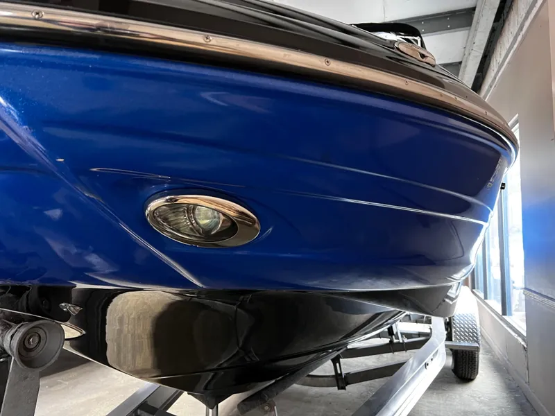 Slide: The Image of 2013 Crownline Eclipse E4 boat, blue hull, close-up view on trailer. - 3