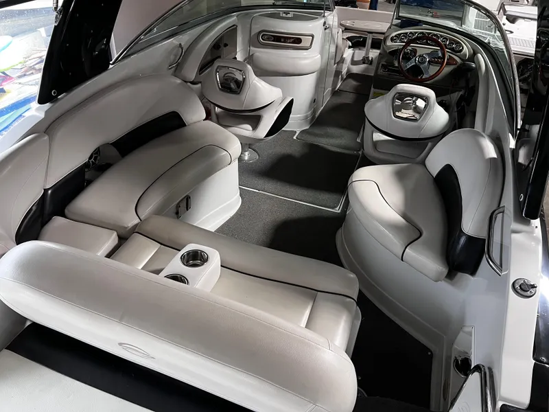 Slide: The Image of 2013 Crownline Eclipse E4 boat interior with plush seating and modern dashboard. - 7