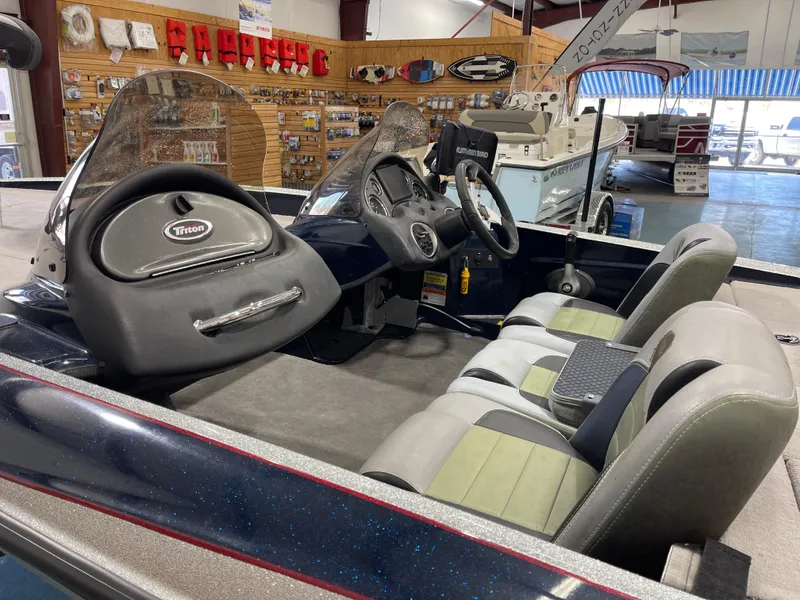 Slide: The Image of 2009 Triton 18 HP Explorer boat interior with dual seats and steering console. - 12