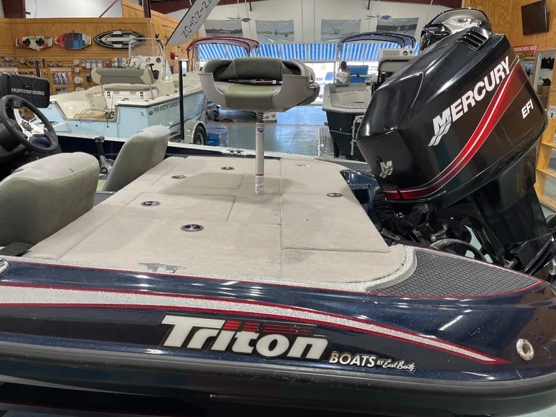 Slide: The Image of 2009 Triton 18 HP Explorer boat with Mercury engine in showroom. - 13