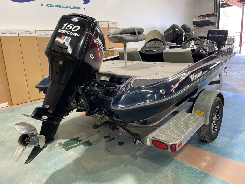 Slide: The Image of 2009 Triton 18 HP Explorer boat with Mercury 150 engine in a showroom. - 16