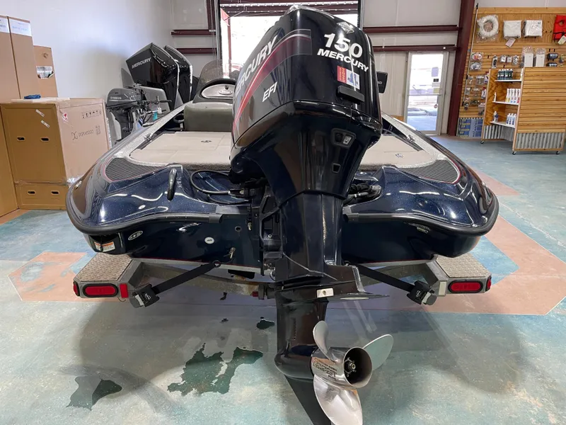 Slide: The Image of 2009 Triton 18 HP Explorer boat with Mercury 150 engine in a showroom. - 17