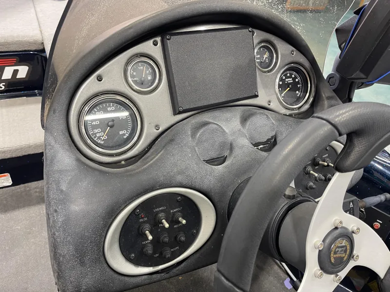 Slide: The Image of Dashboard of a 2009 Triton 18 HP Explorer boat with gauges and controls. - 20